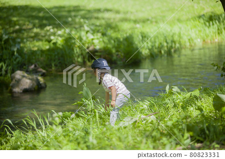 Girl playing around the river Girl playing around the river 80823331