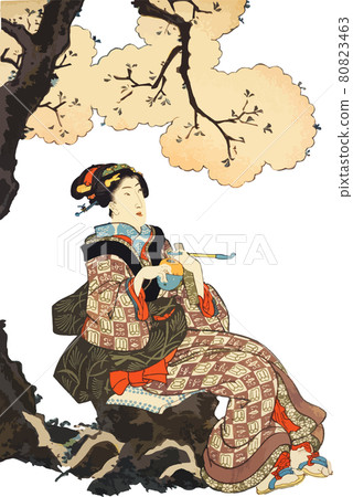 A woman taking a break under the cherry blossoms in full bloom 80823463