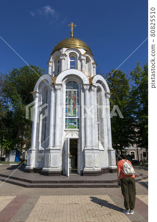 Belgorod, Russia - July 08, 2021: Woman prays before the Saint Prince Vladimir's chapel in Belgorod. Belgorod, Russia - July 08, 2021: Woman prays before the Saint Prince Vladimir's chapel in Belgorod. 80825510