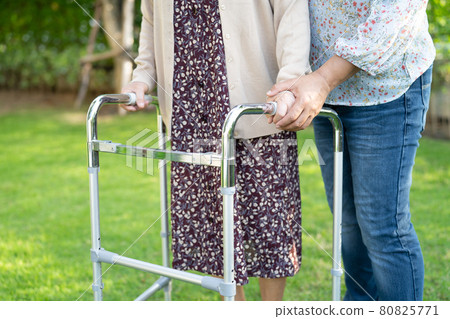 Help and care Asian senior or elderly old lady woman use walker with strong health while walking at park in happy fresh holiday. Help and care Asian senior or elderly old lady woman use walker with strong health while walking at park in happy fresh holiday. 80825771