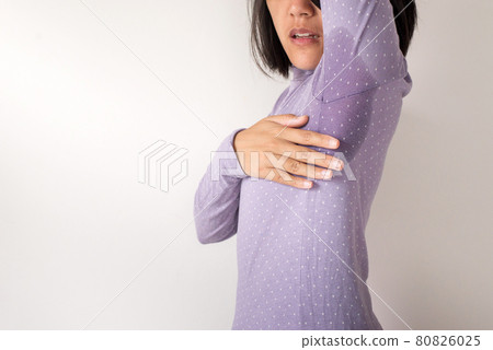 Asian woman with odor sweating,Female smelling or sniffing her armpit,Bad smell,Copy space for text and white background 80826025