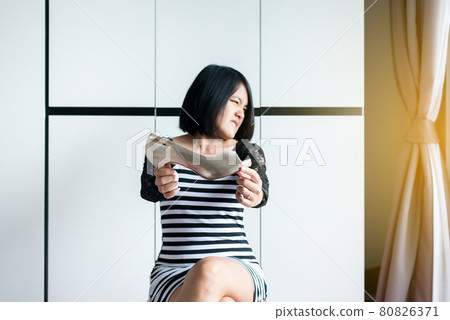 Asian woman hands holding shoe with problem of foot odor and bad smell,Unpleasant snuff stink Asian woman hands holding shoe with problem of foot odor and bad smell,Unpleasant snuff stink 80826371