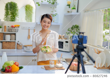 Asian woman recording a video blog Asian woman recording a video blog 80827246