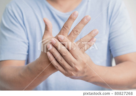 Man hand massage physiotherapy other side is sore and numb, exhausted, tingling. Guillain-Barre Syndrome, a side effect of the Covid-19 vaccination Man hand massage physiotherapy other side is sore and numb, exhausted, tingling. Guillain-Barre Syndrome, a side effect of the Covid-19 vaccination 80827268