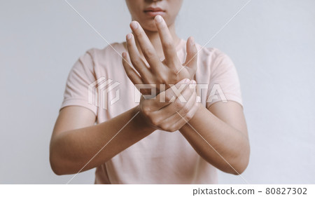 Woman hand massage physiotherapy other side is sore and numb, exhausted, tingling. Guillain-Barre Syndrome, a side effect of the Covid-19 vaccination Woman hand massage physiotherapy other side is sore and numb, exhausted, tingling. Guillain-Barre Syndrome, a side effect of the Covid-19 vaccination 80827302