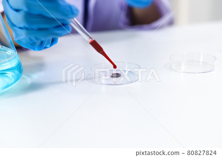 Scientist holding Coronavirus covid-19 infected blood sample tube DNA testing of the blood in the laboratory with blood sample collection tubes and syringe Coronavirus Covid-19 vaccine research. 80827824