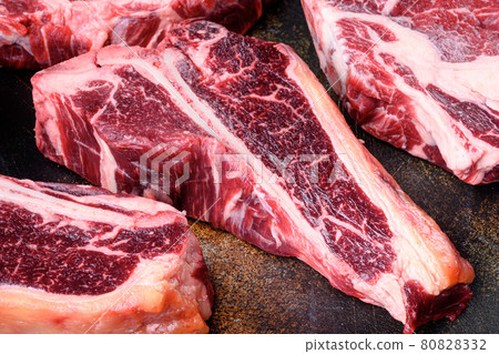 Organic raw beef fresh meat, on old dark rustic background, T bone cut 80828332