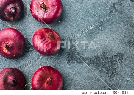 Fresh whole red onion, on gray background, top view flat lay with copy space for text Fresh whole red onion, on gray background, top view flat lay with copy space for text 80828333