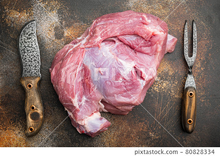 Raw pork meat cut piece, with meat knife and fork, on old dark rustic table background, top view flat lay 80828334