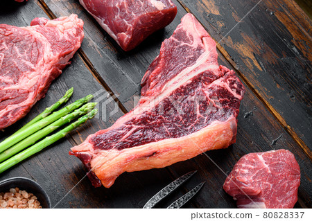 T bone steak. Organic raw Tbon beef marbled meat, on old dark wooden table background T bone steak. Organic raw Tbon beef marbled meat, on old dark wooden table background 80828337