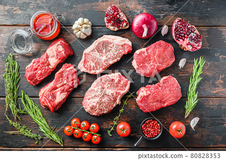Set of organic raw beef steakes rump, chuck roll and top blade cut with seasonings and herbs on old rustic dark wooden background, top view Set of organic raw beef steakes rump, chuck roll and top blade cut with seasonings and herbs on old rustic dark wooden background, top view 80828353