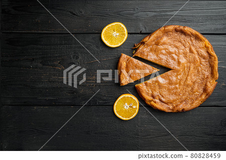Orange and mandarin cake with polenta, on black wooden table background, top view flat lay, with copy space for text Orange and mandarin cake with polenta, on black wooden table background, top view flat lay, with copy space for text 80828459
