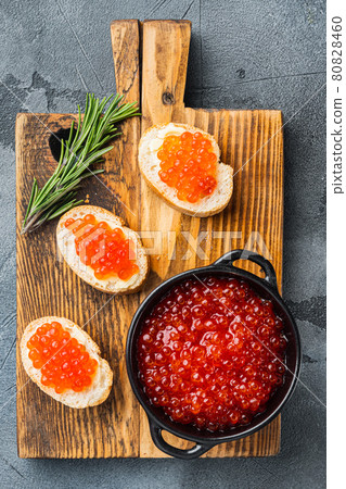 Canape toast with red caviar, on gray background, top view flat lay Canape toast with red caviar, on gray background, top view flat lay 80828460