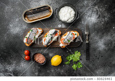 Homemade sardine sandwiches with Ricotta, on black dark stone table background, top view flat lay Homemade sardine sandwiches with Ricotta, on black dark stone table background, top view flat lay 80828461