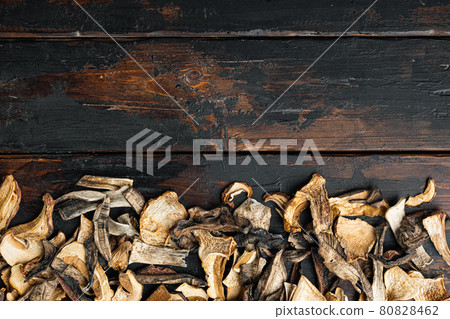 Dried mushrooms, on old dark wooden table background, top view flat lay , with space for text copyspace Dried mushrooms, on old dark wooden table background, top view flat lay , with space for text copyspace 80828462