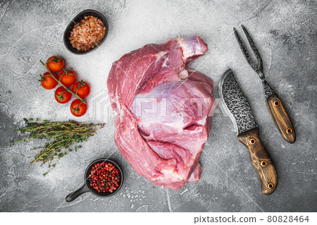 Raw meat, piece of pork with seasonings, on gray stone table background, top view flat lay Raw meat, piece of pork with seasonings, on gray stone table background, top view flat lay 80828464