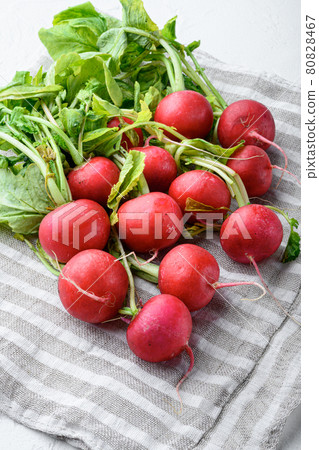 Bunch of radishes. Freshly harvested, purple colorful radish. Growing radish. Growing vegetables. Healthy food background, on white stone background 80828467