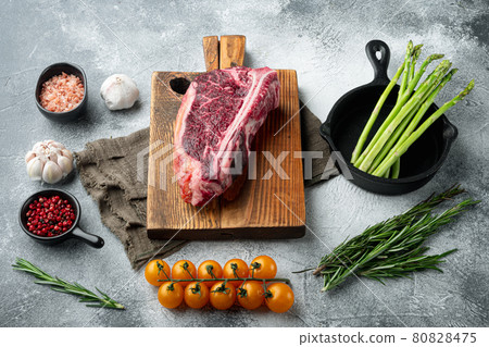 Dry aged Club Steak, seasoning, on gray stone background Dry aged Club Steak, seasoning, on gray stone background 80828475