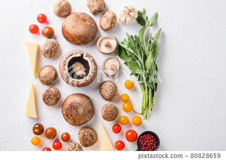 Mushrooms ingredients for baking portobello, cheddar cheese, cherry tomatoes and sage on white background top view space for text. Mushrooms ingredients for baking portobello, cheddar cheese, cherry tomatoes and sage on white background top view space for text. 80828659