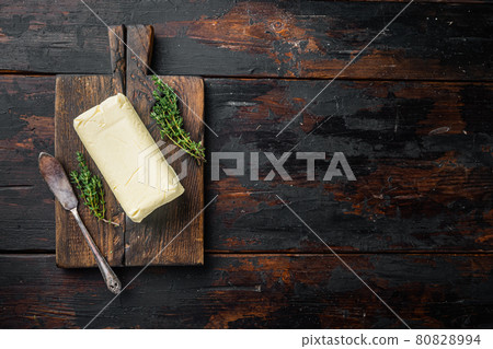 A piece of butter, on old dark wooden table background, top view flat lay with copy space for text A piece of butter, on old dark wooden table background, top view flat lay with copy space for text 80828994