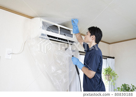 House cleaning worker cleaning the air conditioner 80830188