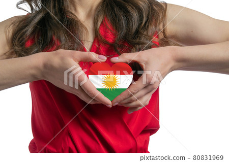 Love Kurdistan. The woman holds a heart in the form of the flag of Kurdistan on her chest. Concept of patriotism 80831969