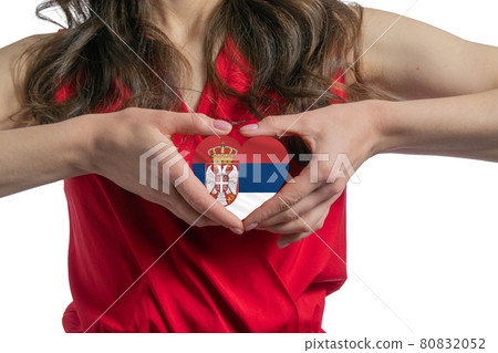 Love Serbia. The woman holds a heart in the form of the flag of Serbia on her chest. Concept of patriotism Love Serbia. The woman holds a heart in the form of the flag of Serbia on her chest. Concept of patriotism 80832052