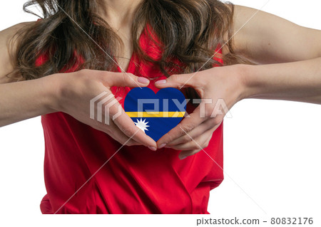 Love Nauru. The woman holds a heart in the form of the flag of Nauru on her chest. Concept of patriotism 80832176