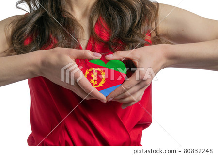 Love Eritrea The woman holds a heart in the form of the flag of Eritrea on her chest. Concept of patriotism Love Eritrea The woman holds a heart in the form of the flag of Eritrea on her chest. Concept of patriotism 80832248