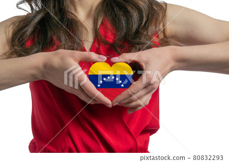Love Venezuela. The woman holds a heart in the form of the flag of Venezuela on her chest. Concept of patriotism 80832293