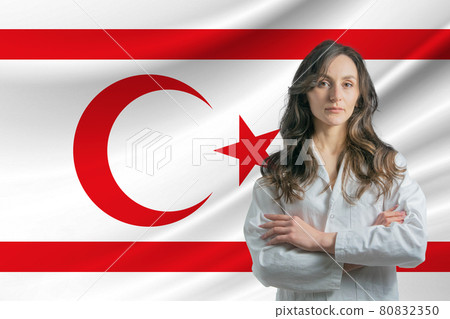 Medicine in Turkish Republic of Northern Cyprus. Happy beautiful female doctor in medical coat standing with crossed arms against the background of the flag of Turkish Republic of Northern Cyprus Medicine in Turkish Republic of Northern Cyprus. Happy beautiful female doctor in medical coat standing with crossed arms against the background of the flag of Turkish Republic of Northern Cyprus 80832350