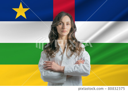 Medicine in Central African Republic. Happy beautiful female doctor in medical coat standing with crossed arms against the background of the flag of Central African Republic 80832375