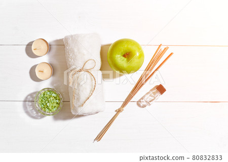 Spa products. Bath salts, soap, candles and towel. Flat lay on white wooden background, top view. Sun flare Spa products. Bath salts, soap, candles and towel. Flat lay on white wooden background, top view. Sun flare 80832833