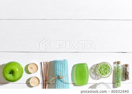 Spa products. Bath salts, soap, candles and towel. Flat lay on white wooden background, top view. 80832840