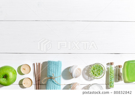Spa products. Bath salts, soap, candles and towel. Flat lay on white wooden background, top view. 80832842