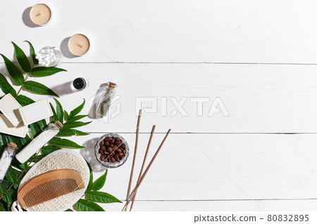 Natural handmade soaps with coffee beans, sea salt, loofah, brown towel and green leaves on white wooden background 80832895