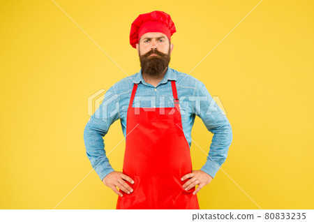 serious bearded chef. brutal male cook in hat and apron. serious bearded chef. brutal male cook in hat and apron. 80833235
