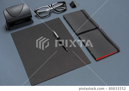 A set of black office accessories, glasses on gray background A set of black office accessories, glasses on gray background 80833552