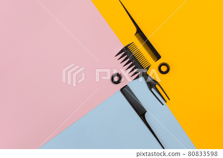 Set of combs on the color pink, yellow, blue paper background.. Top view Set of combs on the color pink, yellow, blue paper background.. Top view 80833598