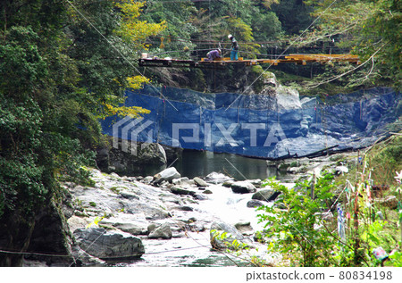 The mountain stream of the Sadamitsu River under the suspension bridge under construction The mountain stream of the Sadamitsu River under the suspension bridge under construction 80834198