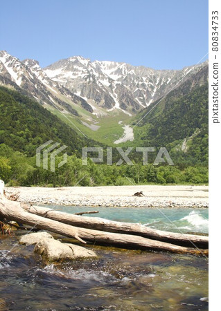 信州上高地、清澈流淌的梓川被春天的清新綠色和背景中可以看到的穗高山脈所環繞 信州上高地、清澈流淌的梓川被春天的清新綠色和背景中可以看到的穗高山脈所環繞 80834733