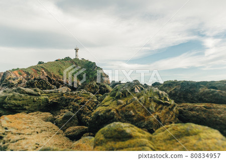 Field of reefs and with lighthouse in the background. Field of reefs and with lighthouse in the background. 80834957