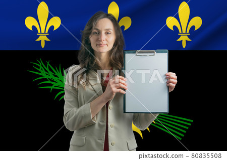 Study in Guadeloupe. Beautiful woman holding a sheet of paper in her hands. Girl on the background of the flag of Guadeloupe Study in Guadeloupe. Beautiful woman holding a sheet of paper in her hands. Girl on the background of the flag of Guadeloupe 80835508