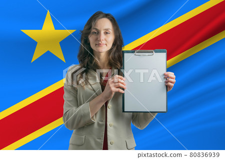 Study in Democratic Republic of the Congo Beautiful woman holding a sheet of paper in her hands. Girl on the background of the flag of Democratic Republic of the Congo Study in Democratic Republic of the Congo Beautiful woman holding a sheet of paper in her hands. Girl on the background of the flag of Democratic Republic of the Congo 80836939