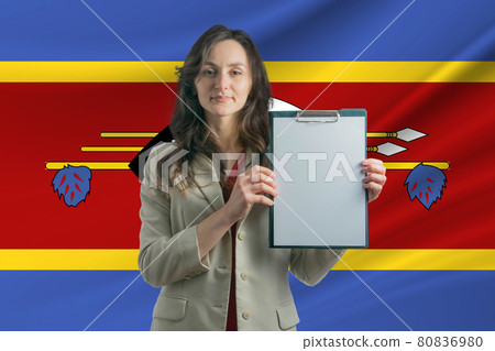 Study in Esvatini Beautiful woman holding a sheet of paper in her hands. Girl on the background of the flag of Esvatini Study in Esvatini Beautiful woman holding a sheet of paper in her hands. Girl on the background of the flag of Esvatini 80836980