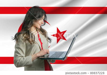 Freelance in Turkish Republic of Northern Cyprus. Beautiful young woman freelancer uses laptop computer against the background of the flag of Turkish Republic of Northern Cyprus Freelance in Turkish Republic of Northern Cyprus. Beautiful young woman freelancer uses laptop computer against the background of the flag of Turkish Republic of Northern Cyprus 80837228