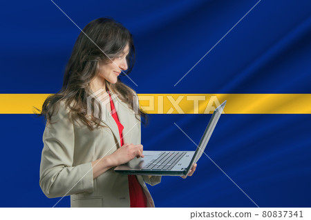 Freelance in Nauru. Beautiful young woman freelancer uses laptop computer against the background of the flag of Nauru 80837341
