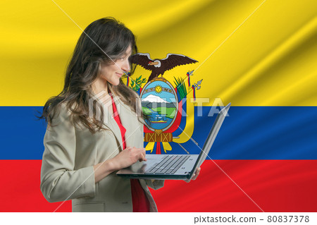 Freelance in Ecuador Beautiful young woman freelancer uses laptop computer against the background of the flag of Ecuador 80837378