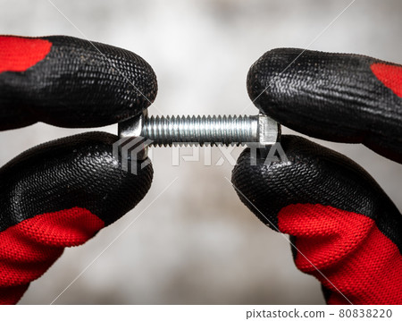 Mechanic holding bolt and nut Mechanic holding bolt and nut 80838220