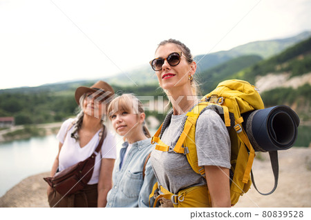 Happy multigeneration family on hiking trip on summer holiday, walking. 80839528